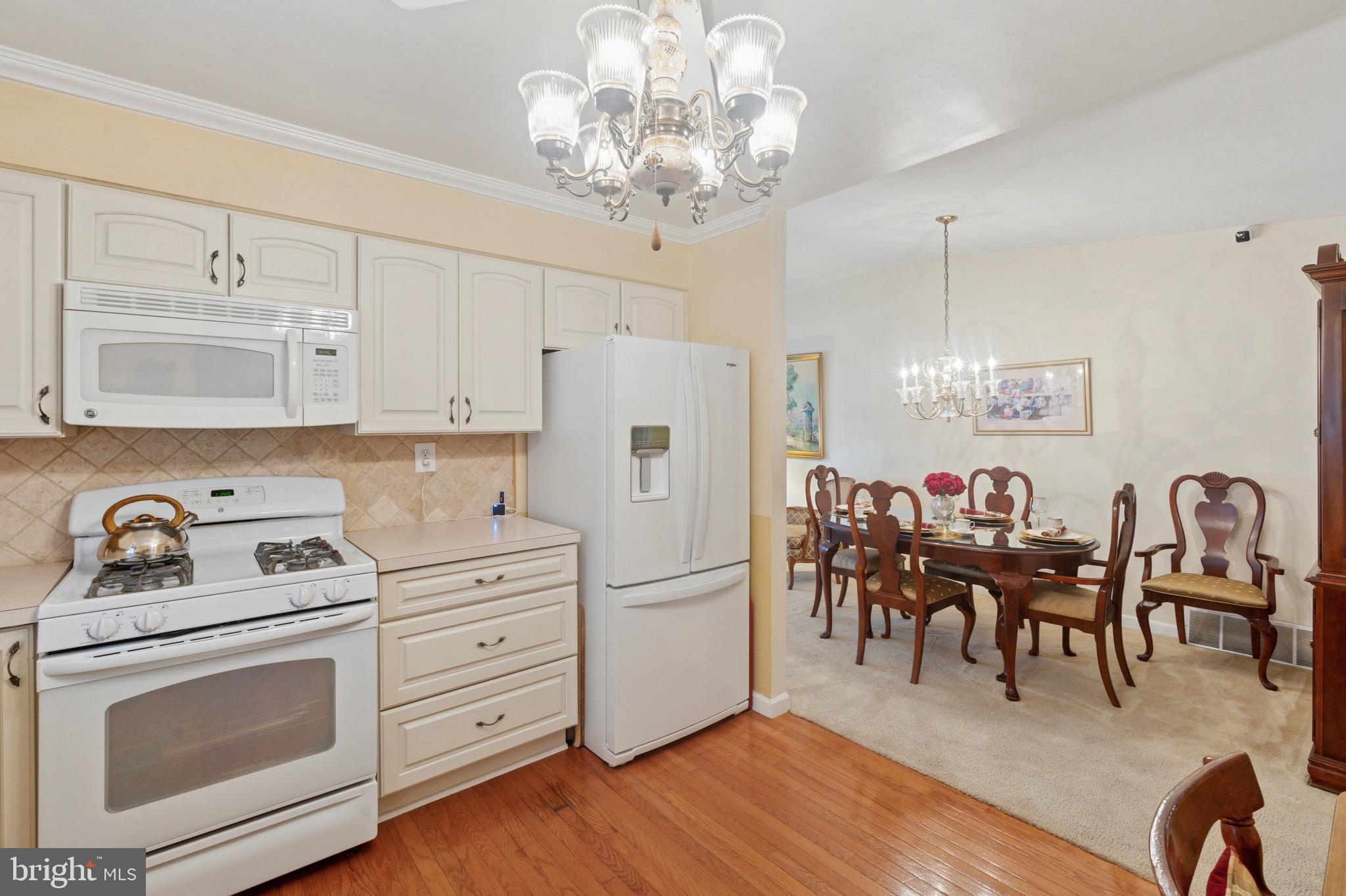 7026 Crease Lane Philadelphia, PA 19128 - Photo 15 of 41 a kitchen with white cabinets and stainless steel appliances