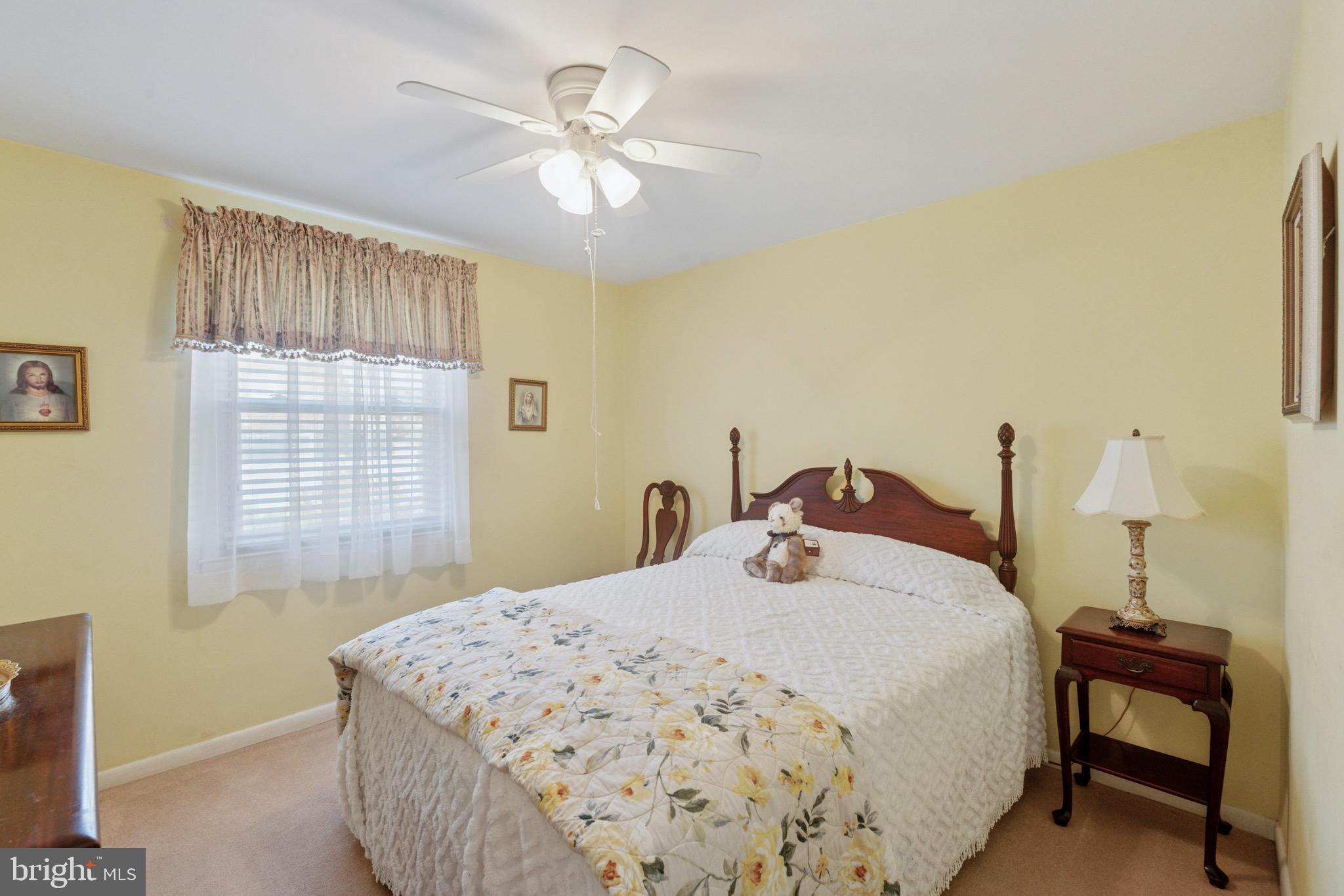 7026 Crease Lane Philadelphia, PA 19128 - Photo 16 of 41 a bedroom with a bed and a chandelier