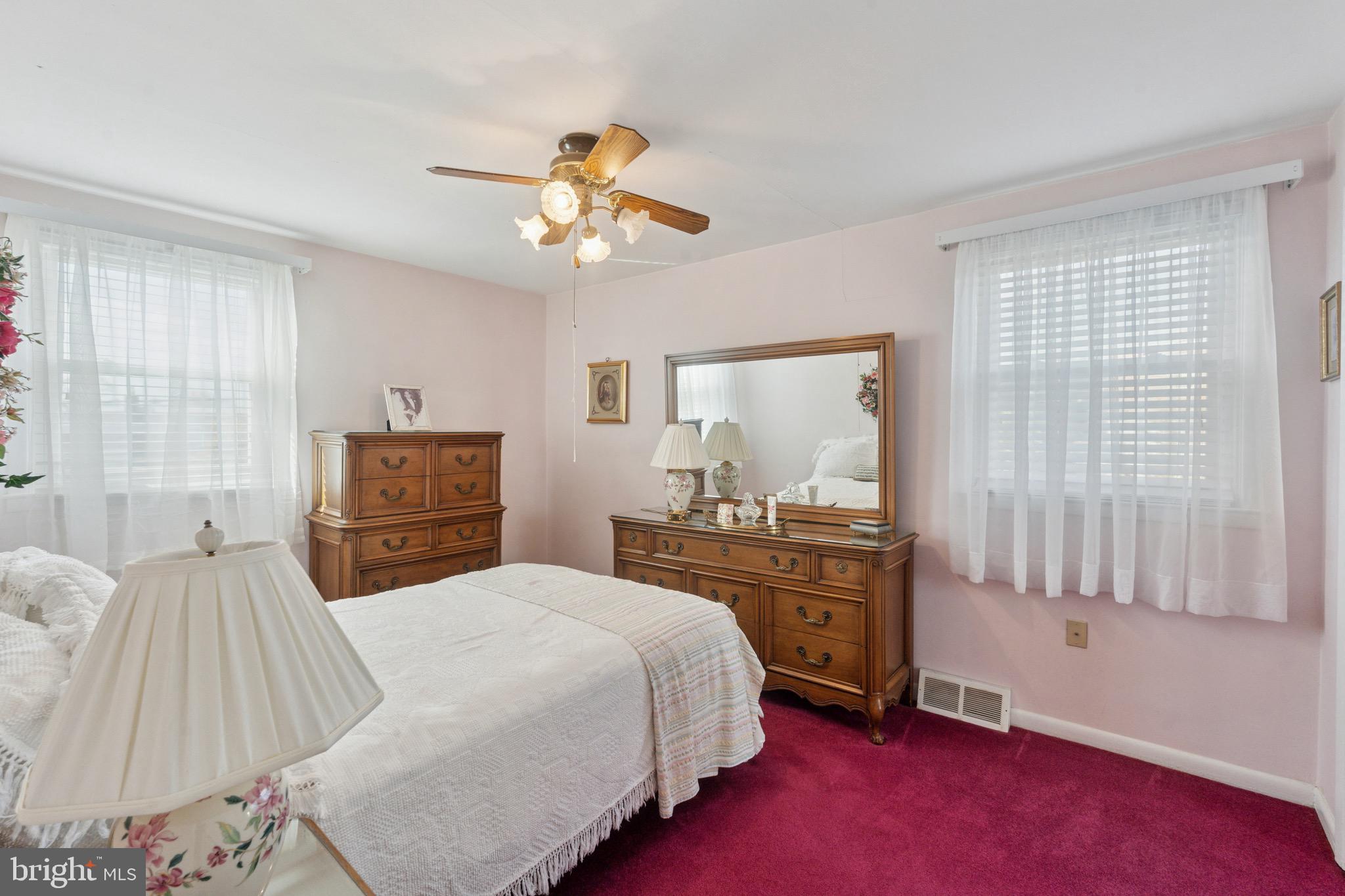 7026 Crease Lane Philadelphia, PA 19128 - Photo 24 of 41 a bedroom with a large bed and a chandelier