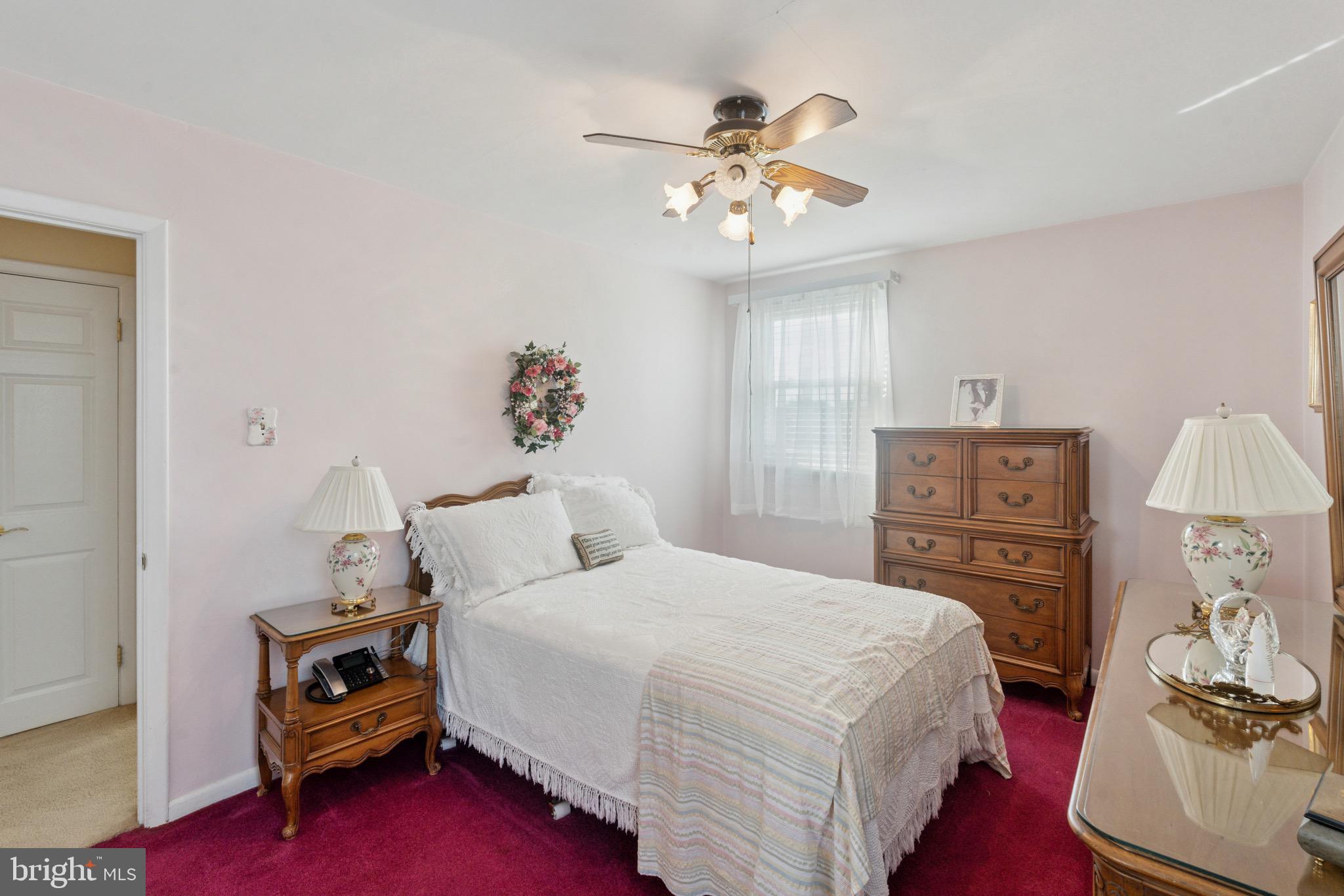 7026 Crease Lane Philadelphia, PA 19128 - Photo 25 of 41 a bedroom with a bed and a chandelier