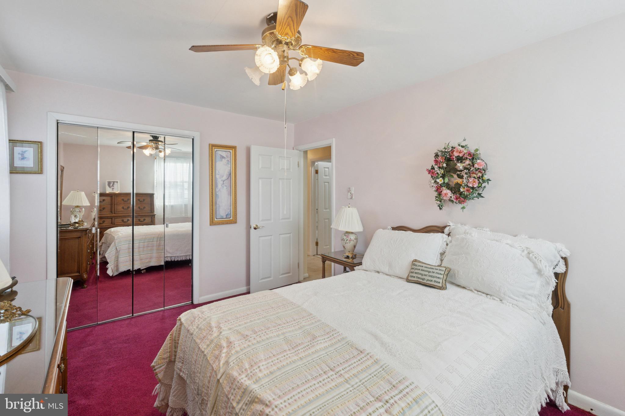 7026 Crease Lane Philadelphia, PA 19128 - Photo 26 of 41 a bedroom with a large bed and a chandelier