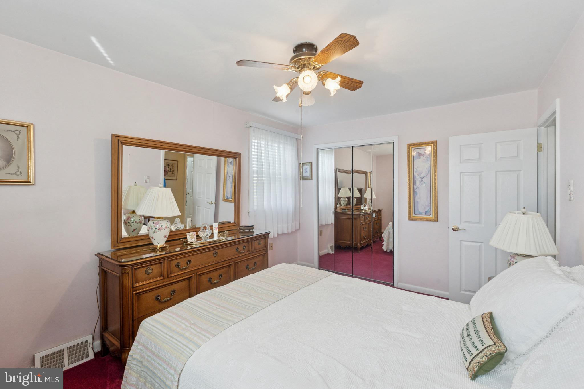 7026 Crease Lane Philadelphia, PA 19128 - Photo 27 of 41 a bedroom with a bed and dresser with mirror