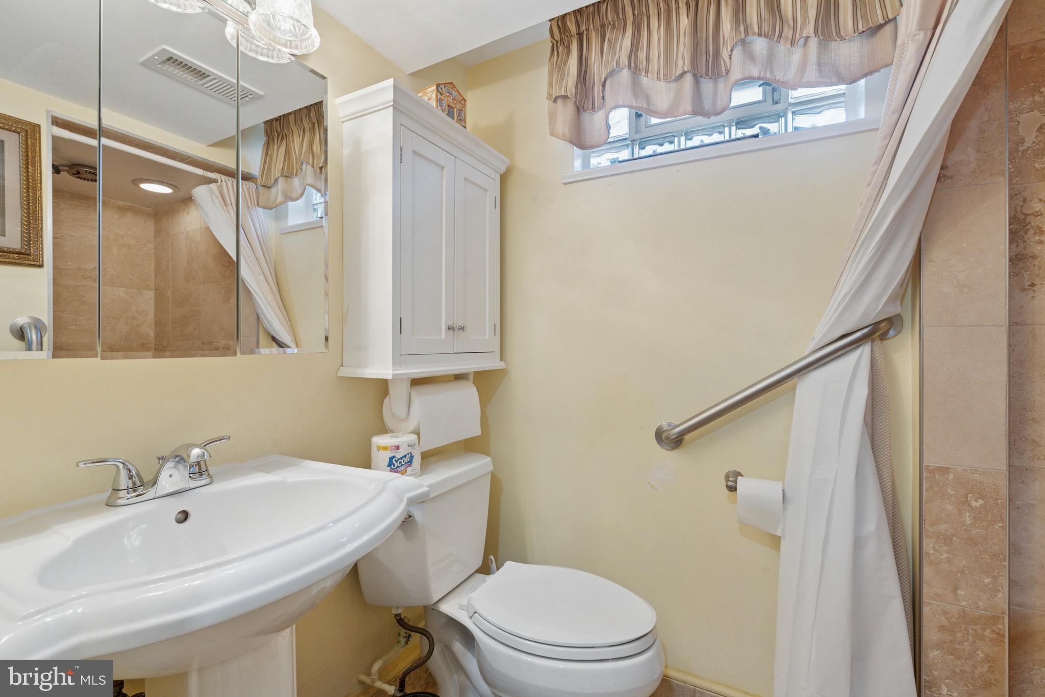 7026 Crease Lane Philadelphia, PA 19128 - Photo 37 of 41 a bathroom with a sink a toilet and shower