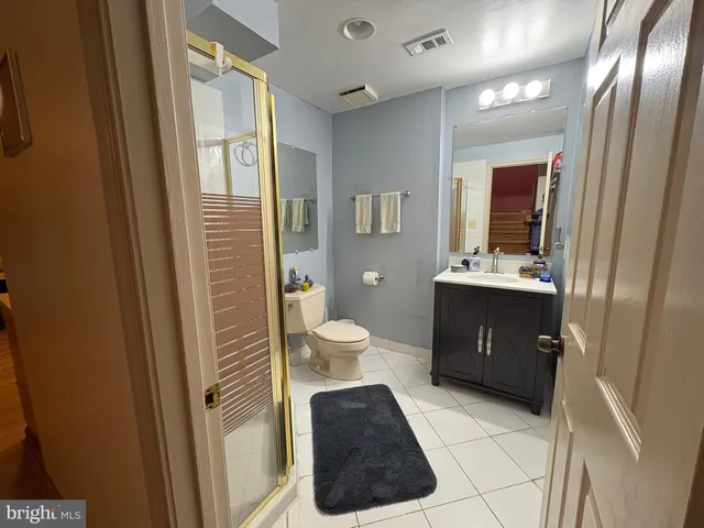 a bathroom with a shower and a sink