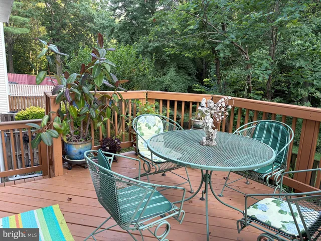a view of a porch with furniture and a yard