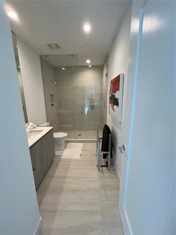 a bed sitting in a bedroom next to a lamp