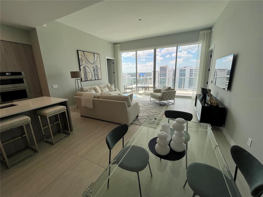 301 Quay Commons, Unit 1808 Sarasota, FL 34236 - Photo 6 of 12 a living room with furniture and a flat screen tv