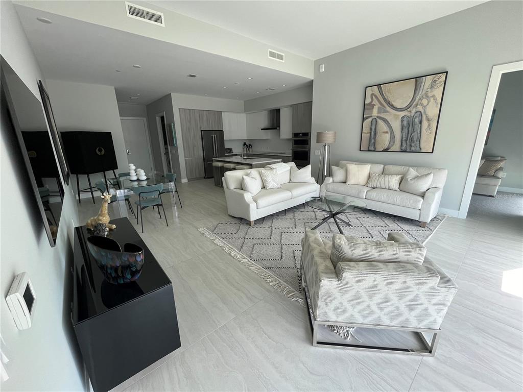 301 Quay Commons, Unit 1808 Sarasota, FL 34236 - Photo 7 of 12 a living room with furniture and a flat screen tv