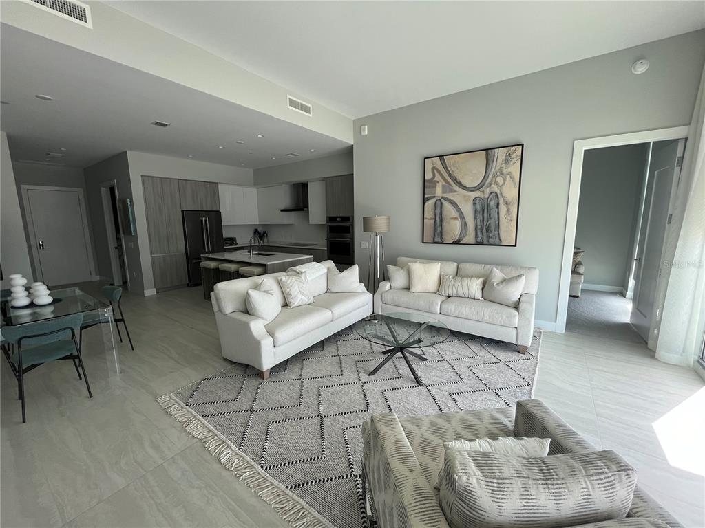 301 Quay Commons, Unit 1808 Sarasota, FL 34236 - Photo 8 of 12 a living room with furniture and a rug