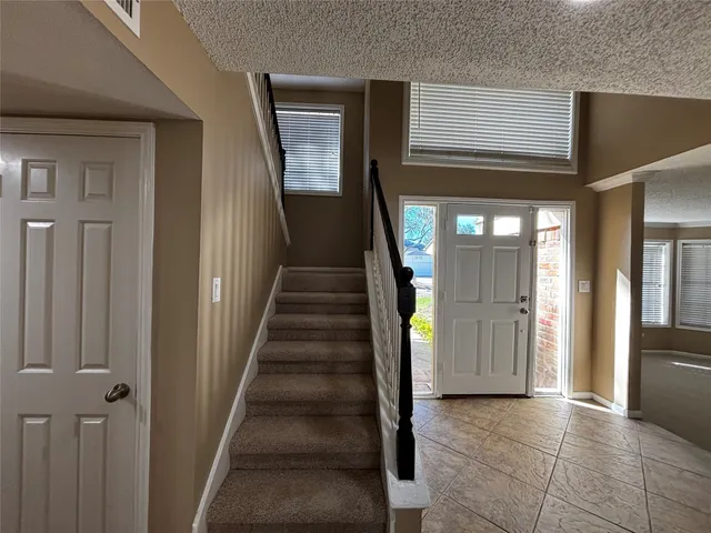 a view of a hallway with wooden floor and entryway