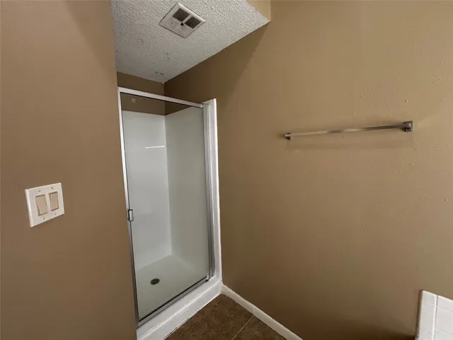 a bathroom with a shower and vanity