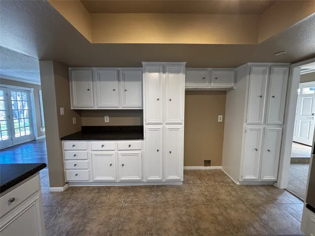 a kitchen with stainless steel appliances a refrigerator sink and cabinets
