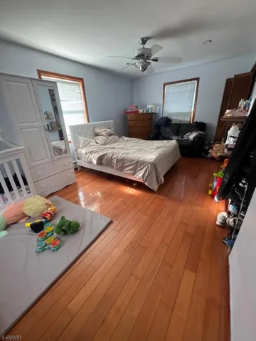 a bedroom with furniture and a wooden floor