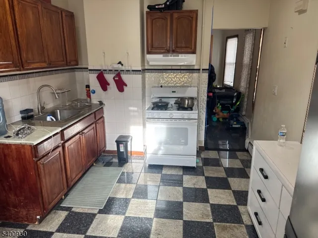 a kitchen with a stove a sink and a refrigerator