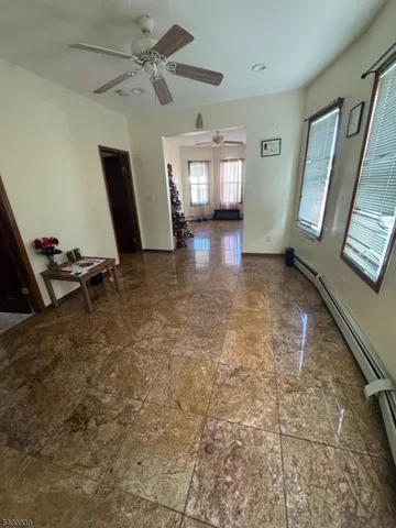 a view of livingroom with hardwood floor and a ceiling fan