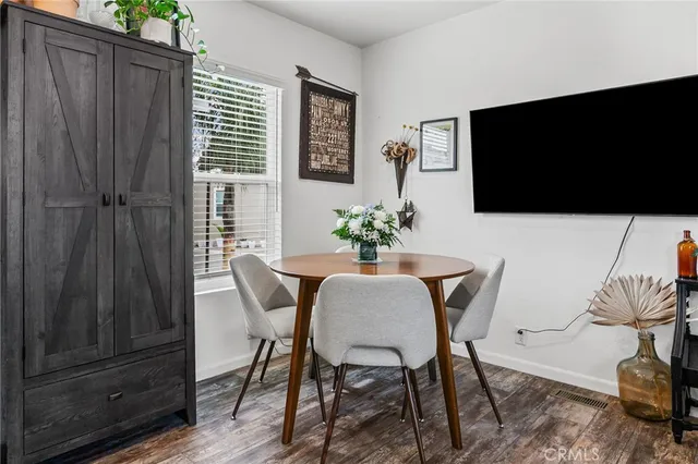 a dining room with furniture and wooden floor
