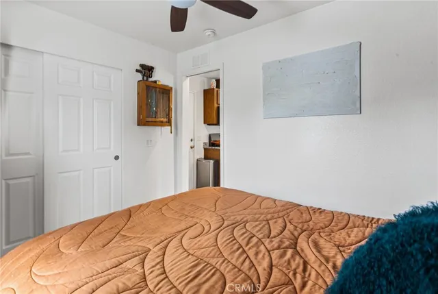 a bedroom with a bed and a painting on the wall