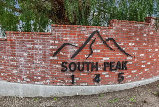 a view of a brick house with a yard