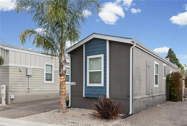 a house that has a tree in front of the house