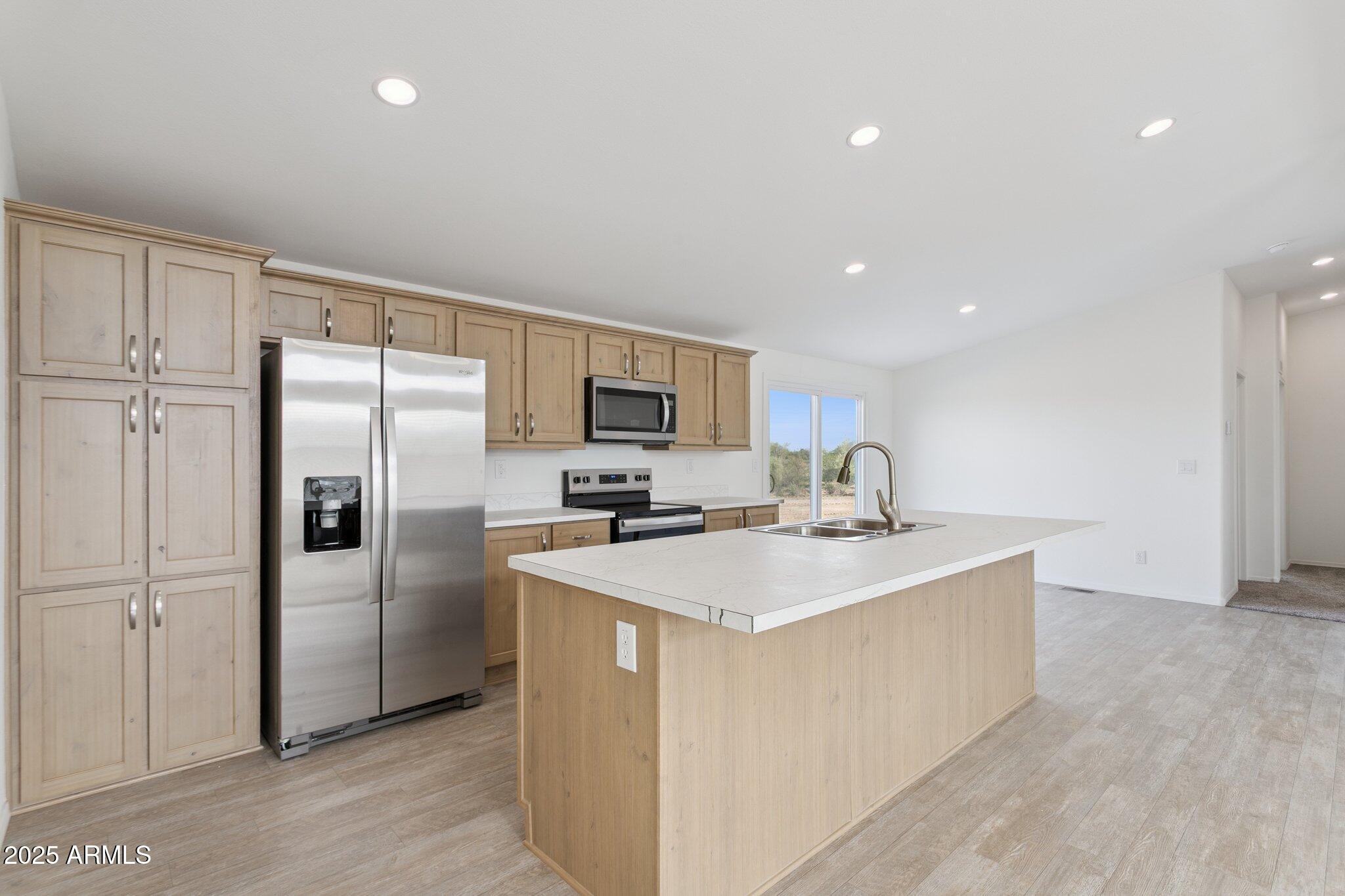 755 North Ralston Road Maricopa, AZ 85139 - Photo 17 of 34 a kitchen with stainless steel appliances a refrigerator sink and microwave