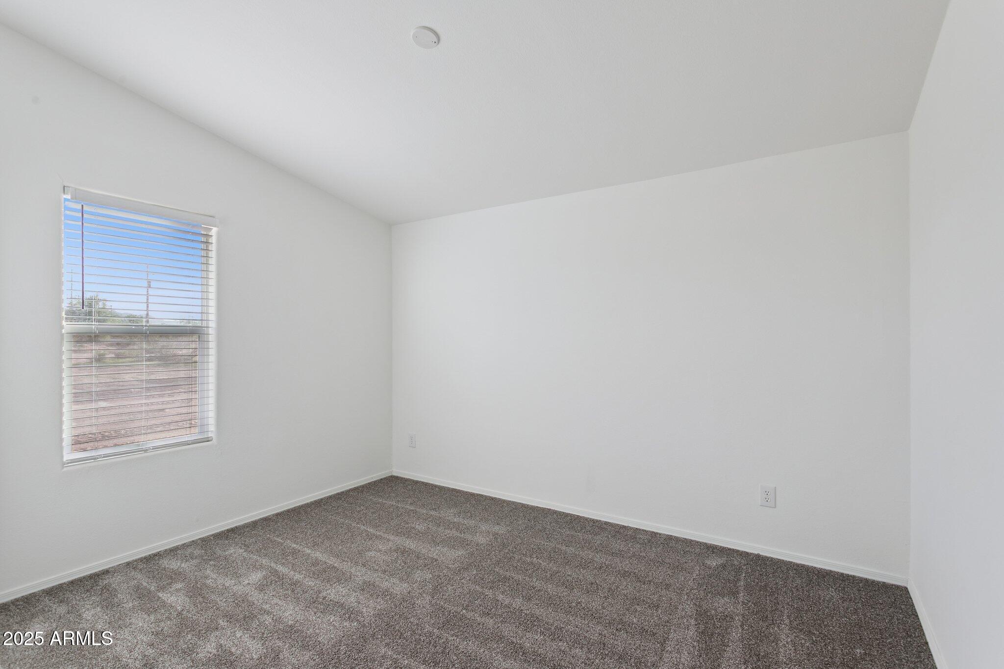 755 North Ralston Road Maricopa, AZ 85139 - Photo 25 of 34 a view of an empty room with a window