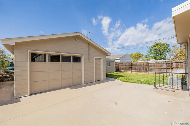 a view of backyard with wooden fence