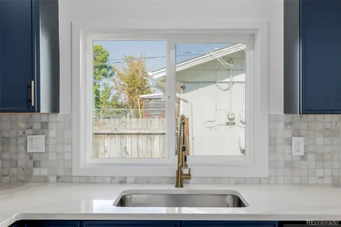 a view of bathroom with a sink and a large window