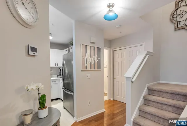 a view of entryway with furniture and wooden floor