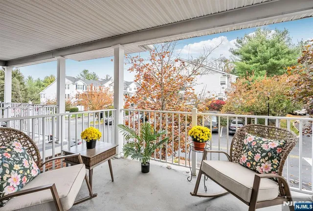 a view of a house with a small deck