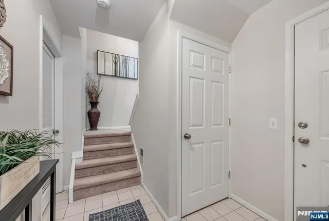 a view of a hallway with wooden floor and entryway