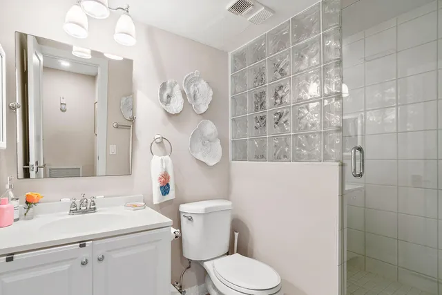 a bathroom with a sink mirror vanity and toilet