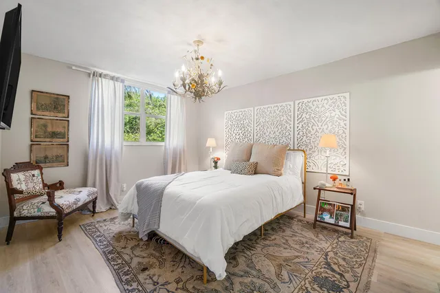 a bedroom with a bed and a chair