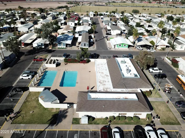 an aerial view of a house with swimming pool and seating area