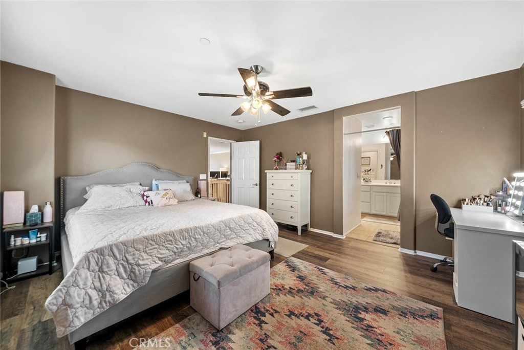 8055 Pueblo Place, Unit 101 Rancho Cucamonga, CA 91730 - Photo 11 of 30 a bedroom with a bed and a chandelier