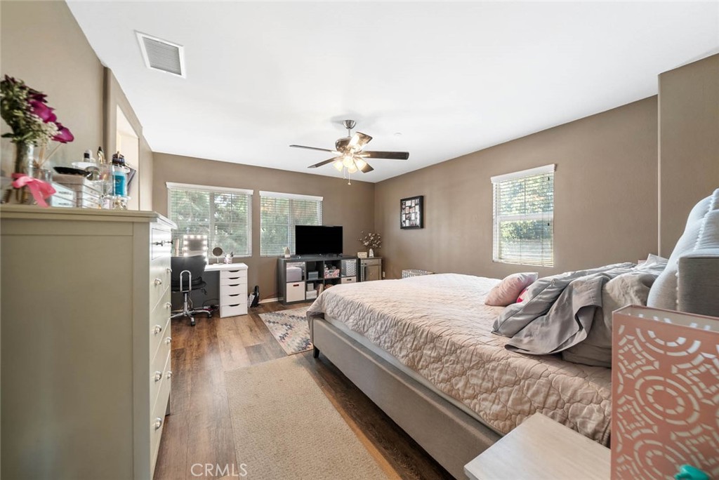 8055 Pueblo Place, Unit 101 Rancho Cucamonga, CA 91730 - Photo 12 of 30 a bedroom with a bed and a chandelier