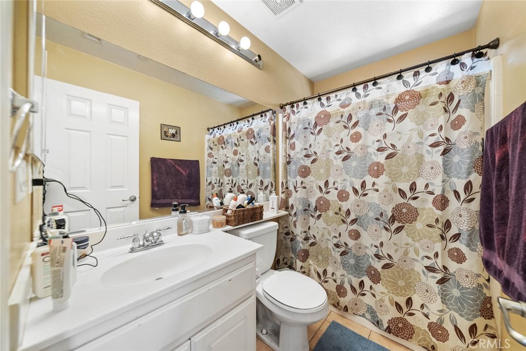 8055 Pueblo Place, Unit 101 Rancho Cucamonga, CA 91730 - Photo 14 of 30 a bathroom with a sink toilet and shower