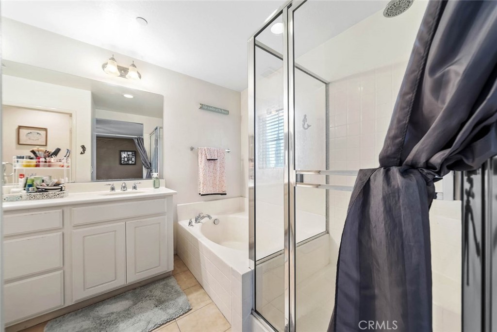 8055 Pueblo Place, Unit 101 Rancho Cucamonga, CA 91730 - Photo 16 of 30 a bathroom with a sink a toilet and a mirror
