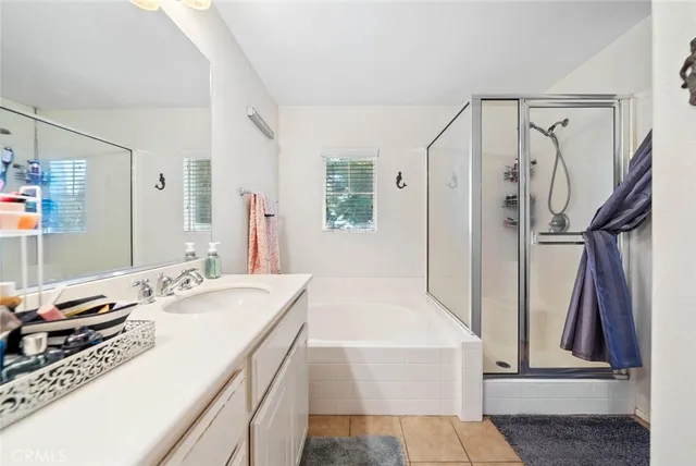a en suite bathroom with a double vanity sink a mirror and a shower