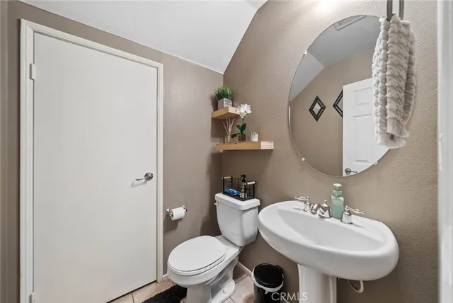 a bathroom with a sink toilet and a mirror