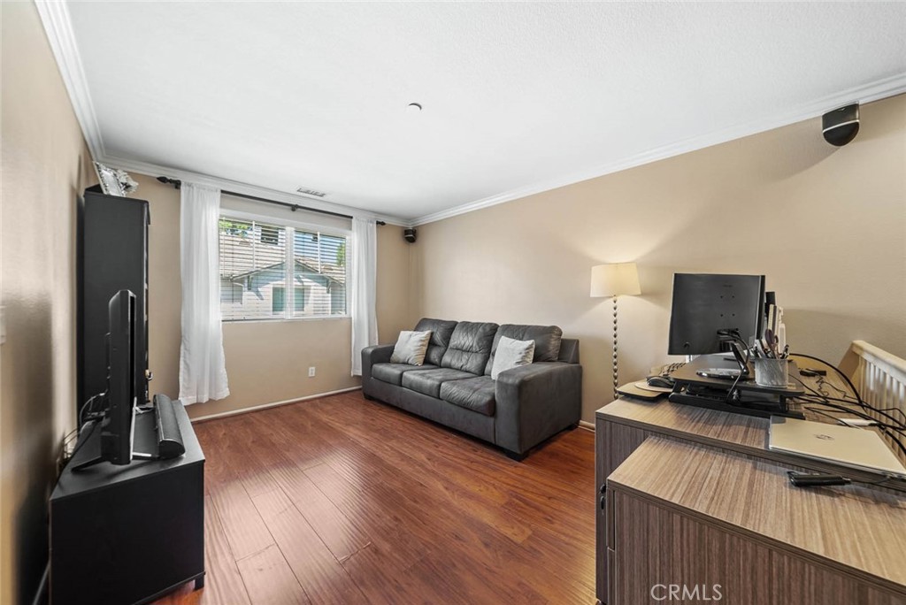 8055 Pueblo Place, Unit 101 Rancho Cucamonga, CA 91730 - Photo 2 of 30 a living room with furniture and a flat screen tv