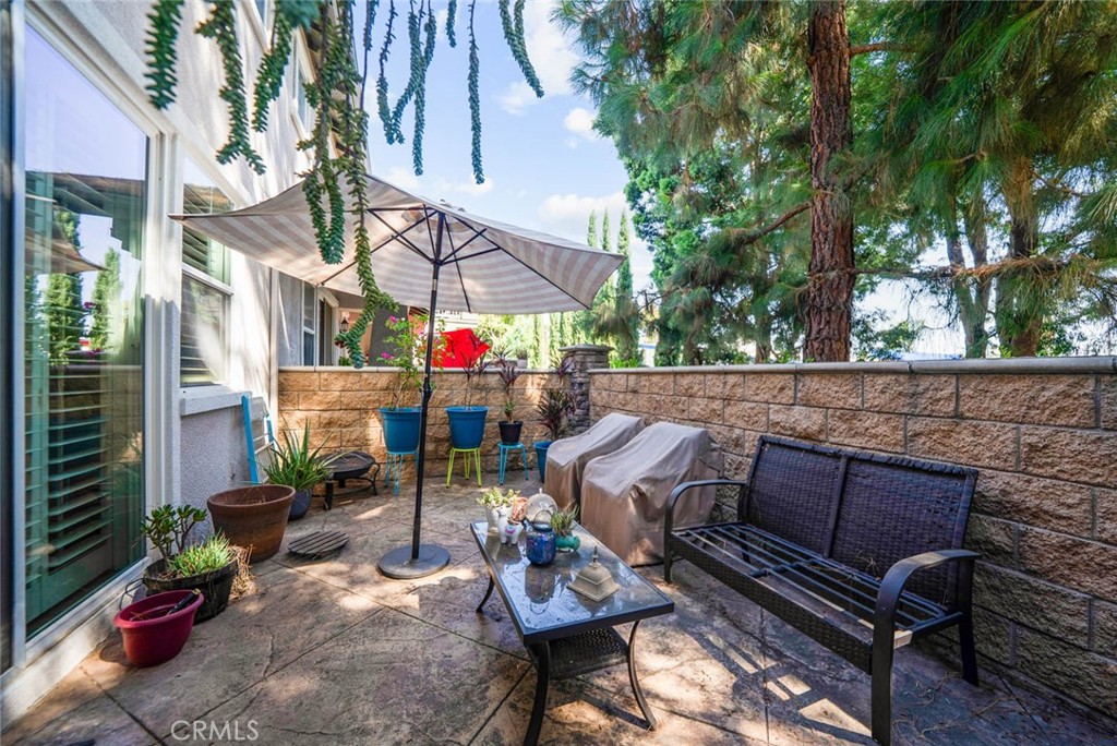8055 Pueblo Place, Unit 101 Rancho Cucamonga, CA 91730 - Photo 21 of 30 an outdoor living area with furniture and a potted plant