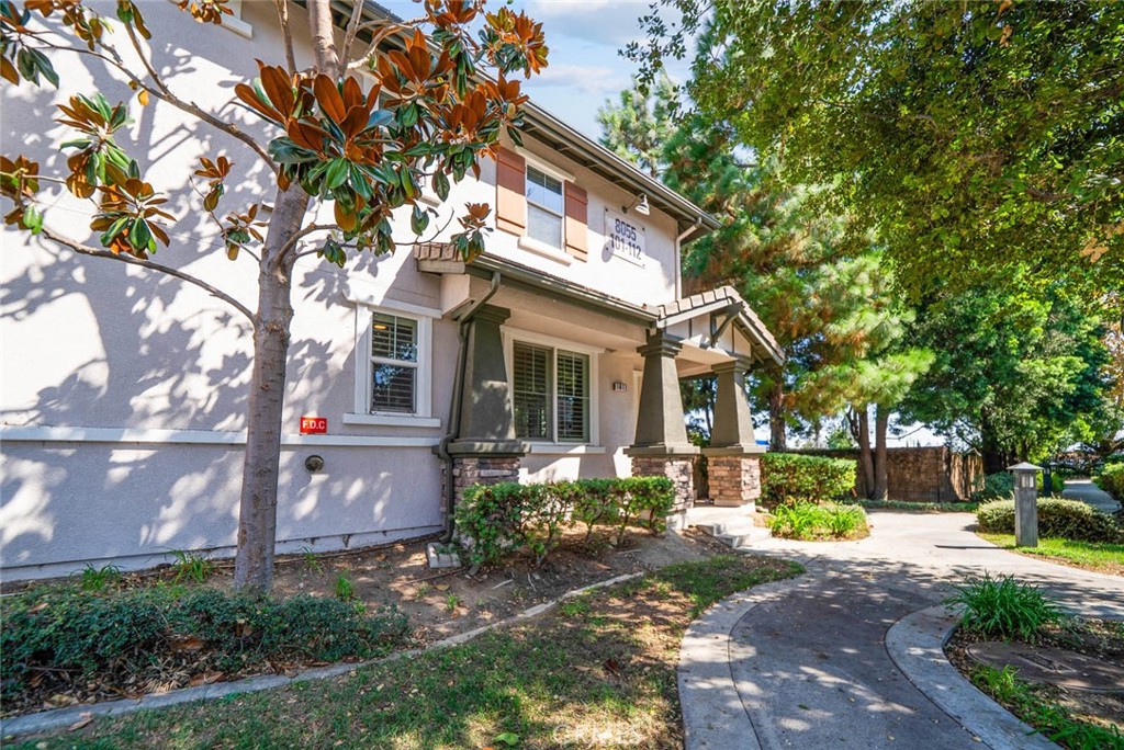 8055 Pueblo Place, Unit 101 Rancho Cucamonga, CA 91730 - Photo 23 of 30 a front view of a house with garden