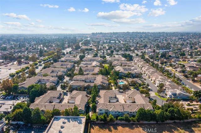 an aerial view of residential houses with outdoor space