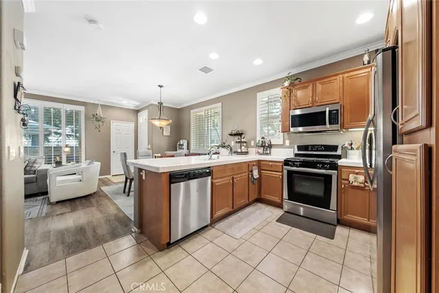 a kitchen with stainless steel appliances a stove a sink and a refrigerator