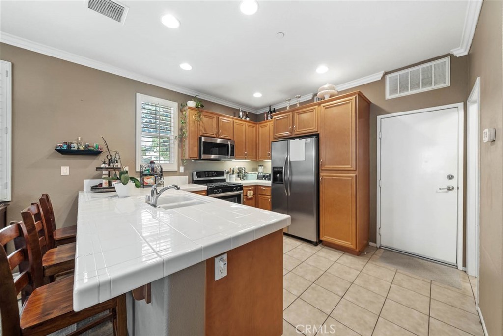 8055 Pueblo Place, Unit 101 Rancho Cucamonga, CA 91730 - Photo 5 of 30 a kitchen with refrigerator cabinets and wooden floor