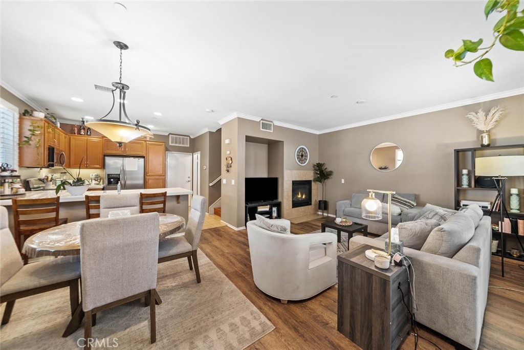8055 Pueblo Place, Unit 101 Rancho Cucamonga, CA 91730 - Photo 8 of 30 a living room with fireplace furniture and a chandelier