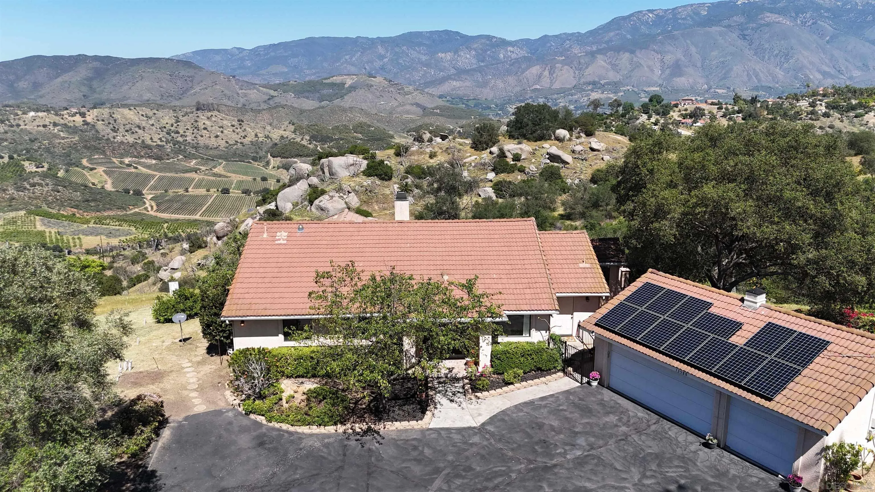 13588 McNally Road Valley Center, CA 92082 - Photo 1 of 43 an aerial view of a house with a garden