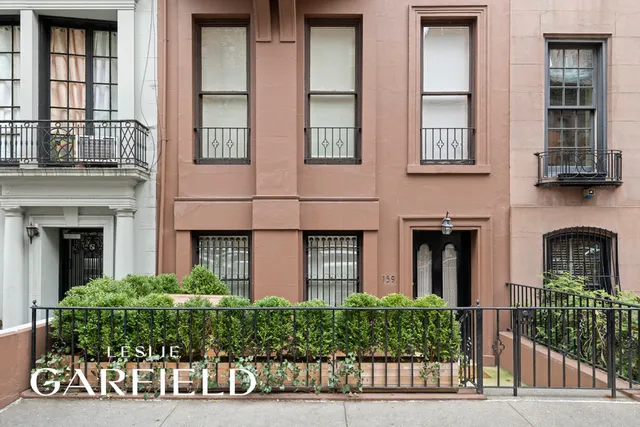 a bedroom with a bed window and walk in closet