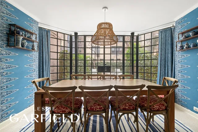 a view of a patio with table and chairs potted plants and a large tree