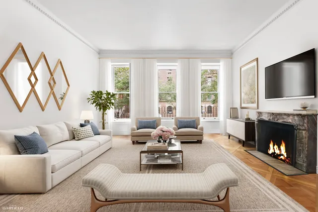 a living room with furniture fireplace and a large window